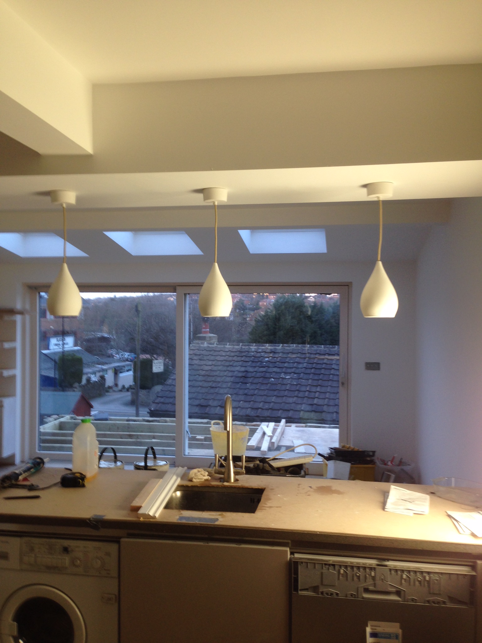 Three pendant lights over a kitchen counter